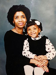 Mother holds daughter on her lap