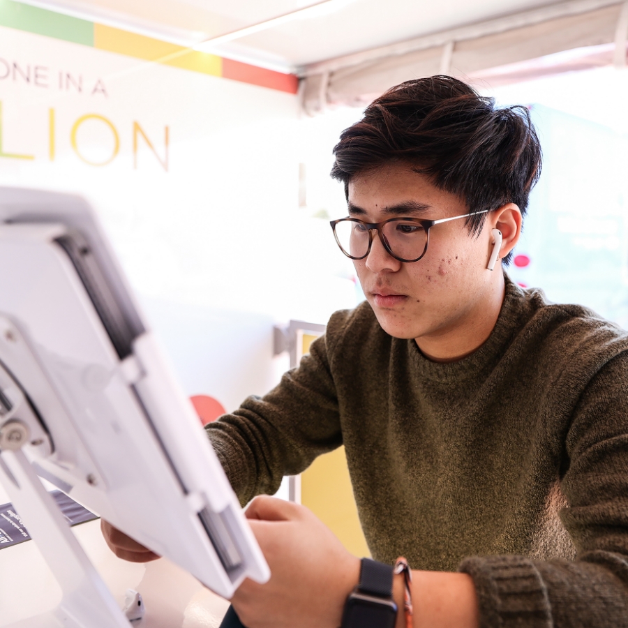 Young man scrolling through a tablet